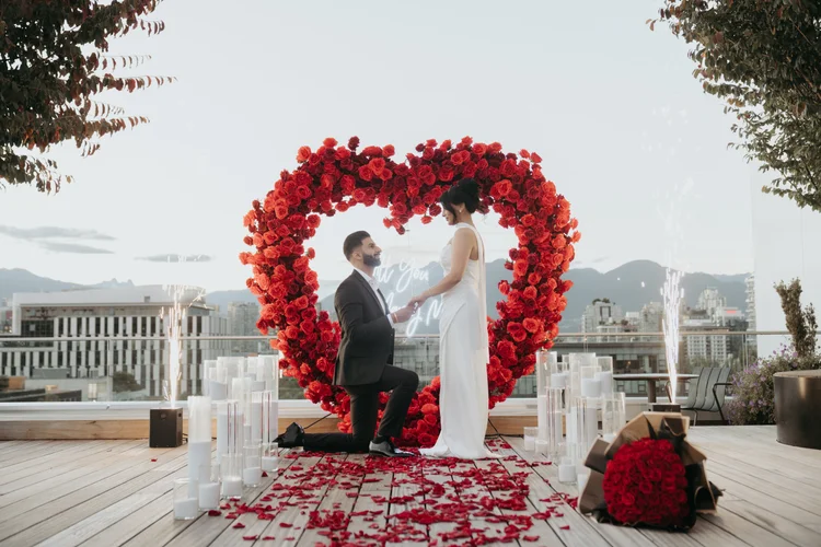 Luxe red floral heart arch proposal on rooftop with Vancouver skyline