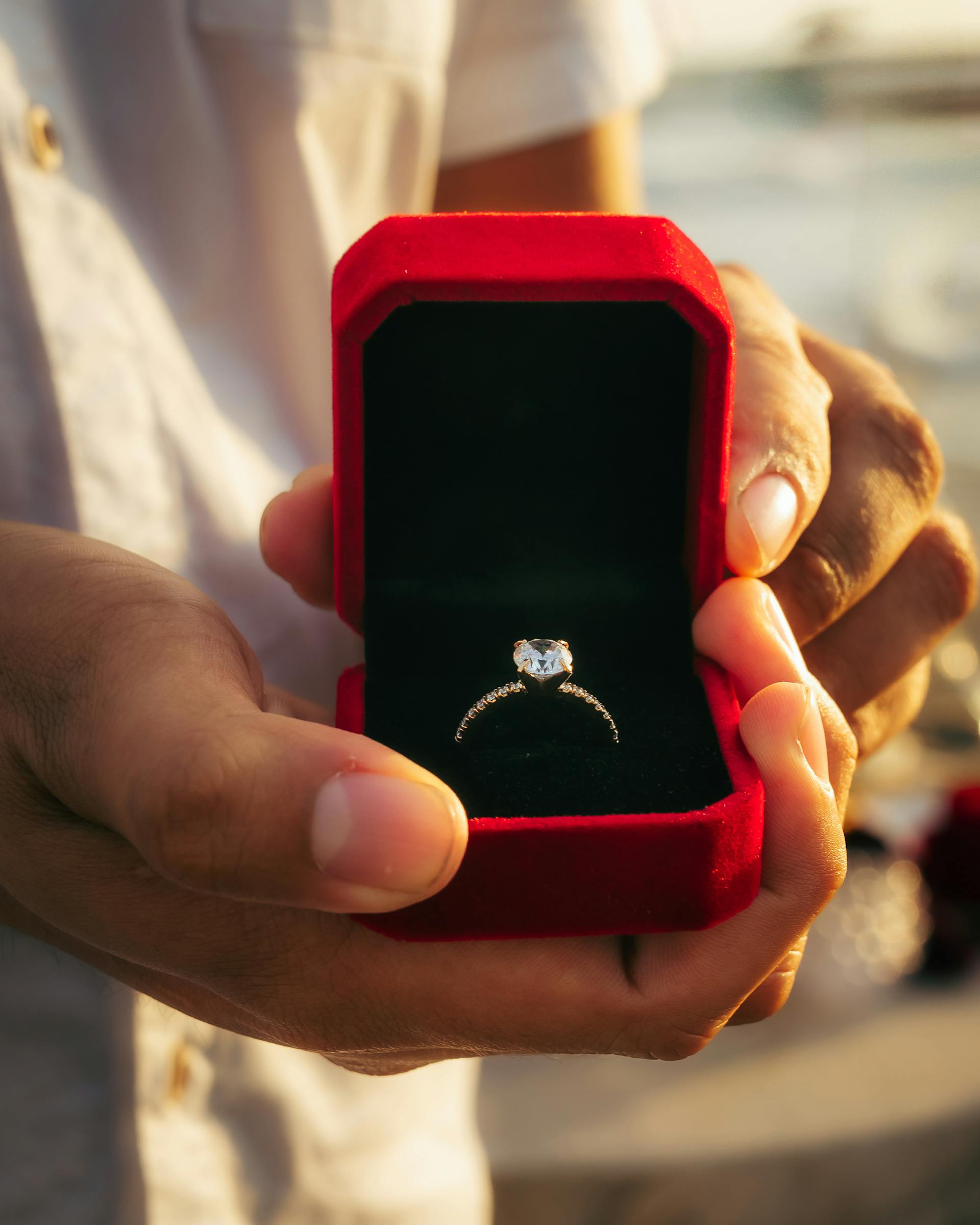 Engagement ring presented in red velvet box at proposal